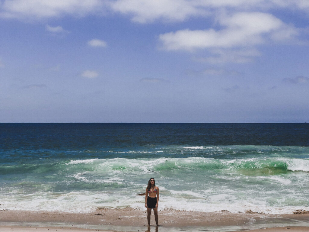 Mulher com os pés na água em Laguna Beach